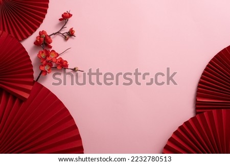 Chinese New Year celebration background with red paper fans and flowers. Asia traditional cultural decoration. Empty space. decoration backdrop idea for the year-end party.