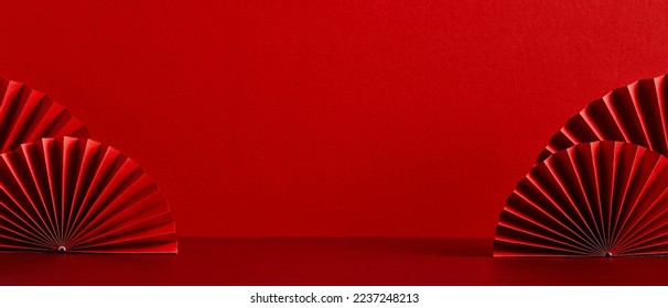 Chinese New Year celebration concept. Banner design with red paper fans decorations on red background with copy space. - Shutterstock ID 2237248213