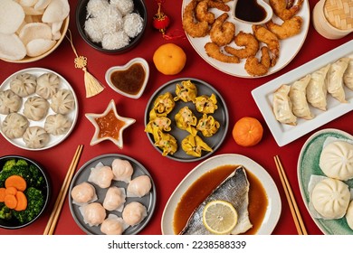 Chinese new year festival table over red background. Traditional lunar new year food. Flat lay, top view - Shutterstock ID 2238588339