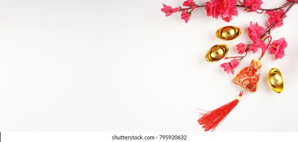Chinese New Year flat lay background with assorted festival decorations. Chinese characters on gold ingot means abundant of wealth.