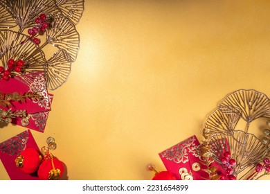 Chinese New Year gold red background. Lunar New Year greeting card flatlay with traditional festival decoration - ginkgo biloba branches decor, twigs, berries, gift envelopes, coins, Chinese lanterns - Shutterstock ID 2231654899