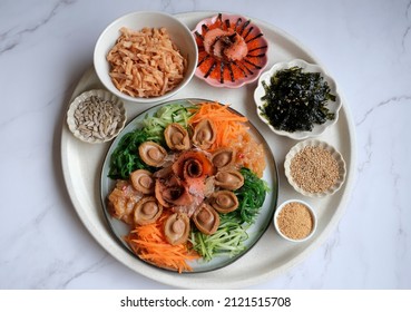 Chinese New Year must have dish. Yusheng aka Prosperity Toss with Abalones. Homemade Cantonese style raw fish salad celebrating with family members