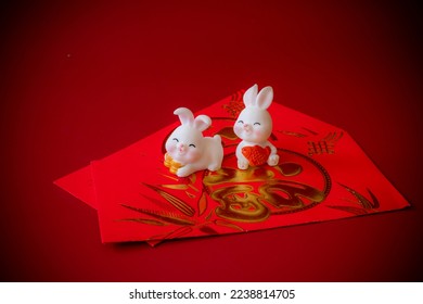 Chinese New Year of the rabbit festival concept. Rabbit on red envelopes isolated on red background. Happy New Year Chinese Rabbit 2023. 