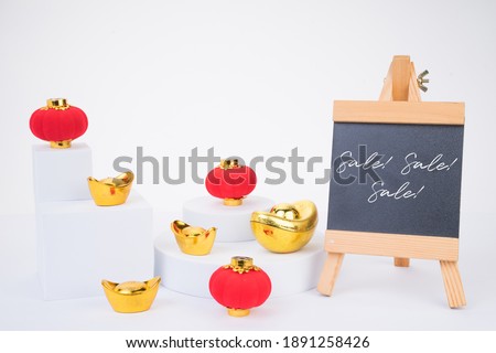 Chinese New Year sale or promo template. Red lanterns and gold ingot with blackboard on white isolated background. Chinese characters on gold ingot means prosperity 