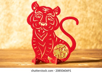 Chinese New Year of tiger 2022 mascot paper cut on a wood table in the morning the Chinese translation is fortune no logo no trademark