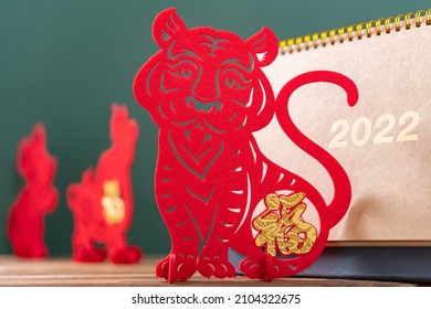 Chinese New Year of Tiger mascot paper cut and a 2022 calendar in front with Rat and Ox mascots at back, the Chinese means Happy New Year no logo no trademark