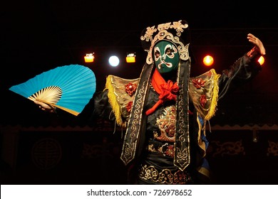 Chinese Opera Actor Performs Traditional Drama Onstage With Theatrical Costume And Mask