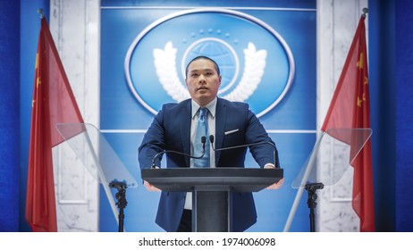 Chinese Organization Representative Speaking At Press Conference. Press Officer Delivering A Speech At Summit. Minister Speaking At Congress Hearing. Backdrop With People's Republic Of China Flags.