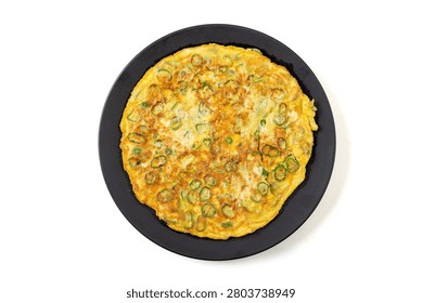 chinese pan fried egg flatbread with chopped green chili peppers on green ceramic plate