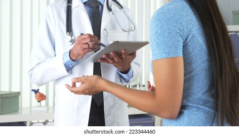 Chinese patient talking to hispanic doctor - Powered by Shutterstock