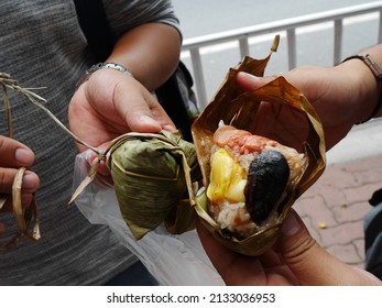 Chinese people and foreign travelers buy and eat Zongzi or chinese sticky rice dumpling from at local restaurant in Market Street Teochew old town at Chaozhou city capital urban in Guangdong, China