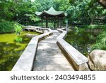 Chinese pergola over pond in Chinese Garden, Hong Kong.