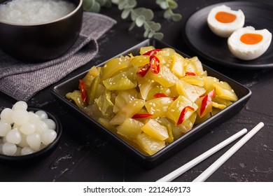 chinese pickled mustard greens , spicy salad pickle cabbage with sesame oil on black background - Shutterstock ID 2212469173