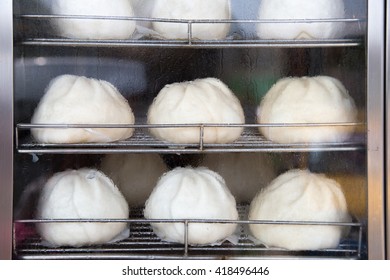 Chinese Pork Bun Or Steamed Dumpling In Steam Cabinet Warming For Sale Ready To Eat In Minimart.