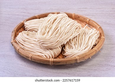 Chinese raw noodle on bamboo basket - Shutterstock ID 2257617159