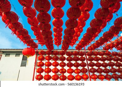 Chinese red lanterns hanging above a house againt blue sky for decoration during the Chinese New Year festival at Chinatown, Ratchaburi, Thailand