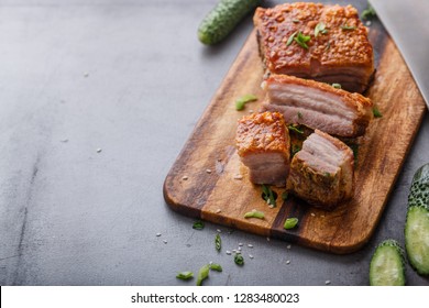 Chinese roasted pork belly on wooden cutting board copy space.