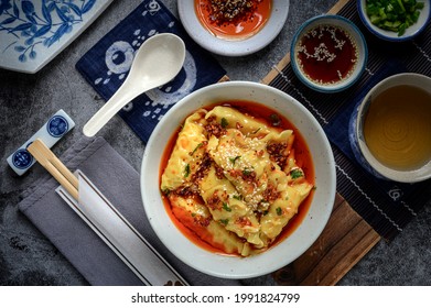 Chinese Sichaun Cuisine; Original Hot And Spicy Sichuan Pickled Chilli Oil Shrimp Wonton Soup With Green Onion And Tea Set In The Studio Lighting