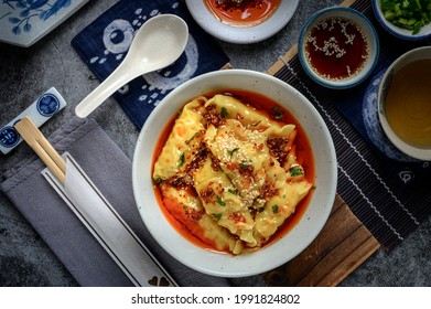 Chinese Sichaun Cuisine; Original Hot And Spicy Sichuan Pickled Chilli Oil Shrimp Wonton Soup With Green Onion And Tea Set In The Studio Lighting