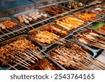 Chinese snacks including pork, meatballs, intestines and seafood brochettes displayed in a popular street market at Nanjing Road at night, Shanghai, China