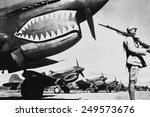 Chinese soldier guards a line of American P-40 fighter planes, ca. 1942. The shark-face fighters of the 