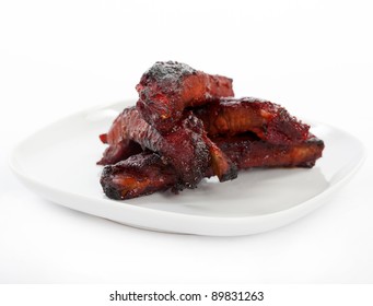 Chinese Spare Ribs On A Plate Isolated On White.