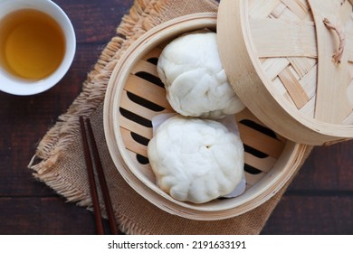 Chinese Steamed Buns In Bamboo Steamer On Wood Table At Top View