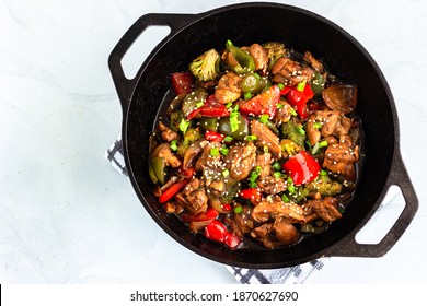 Chinese Stir-Fried Chicken And Vegetables In A Wok Top Down Photo On White Background