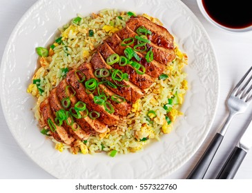 Chinese Style Egg Fried Rice With Sliced Pork Fillet On White Wooden Table.