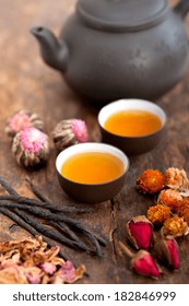 Chinese Style Herbal Floral Tea Over Wood Table With Raw Ingredients