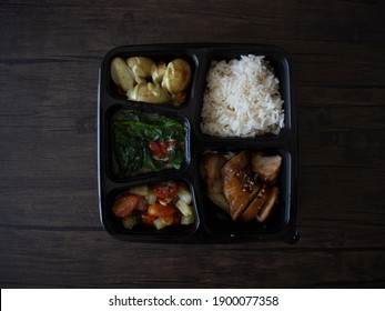 Chinese Style Rice Bento. Chinese Takeaway In A Bento Box. Bento Flatlay On Wooden Table, Top Down Shot.