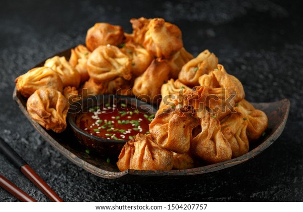 Chinese takeaway finger food Vegetable\
wontons with sweet chilli dip sauce and chop\
sticks