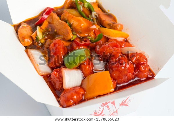 Chinese\
Takeaway Food - Chicken Manchurian, Sweet & Sour Chicken,\
Sichuan Chicken in a Chinese takeaway\
box