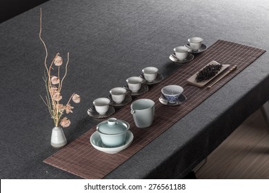 Chinese tea set and gray and towels