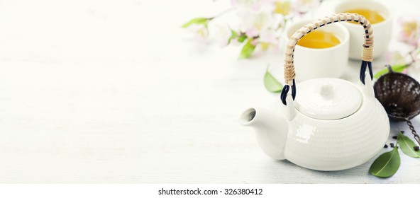 Chinese Tea Set  and sakura branch on bamboo mat