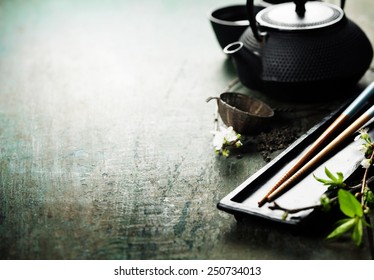 Chinese Tea Set,chopsticks and sakura branch on rustic wooden table