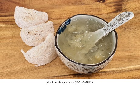 Chinese Traditional Medical Products Bird's Nest Soup and Raw Bird's Nest by swiftlets solidified saliva isolated on table, one of the most luxurious and expensive Nutritional product in the world.