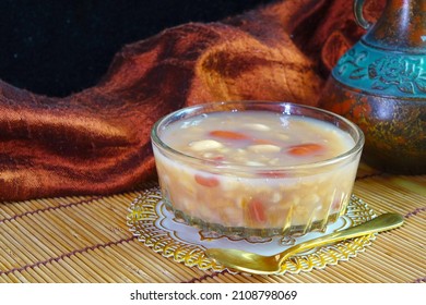 Chinese Traditional Mixed Rice Congee In Glass Bowl. Rice Congee Made With Red Beans, Lotus Seeds, Longan, Red Dates, And Nuts. Sweet Congee, Selective Focus