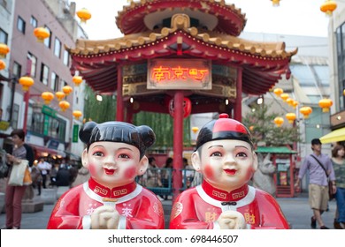 Chinese traditional statues outside one of the streets of Yokohama Chinatown, one of the busiest touristic areas of Japan. The Chinese characters mean "chinatown"