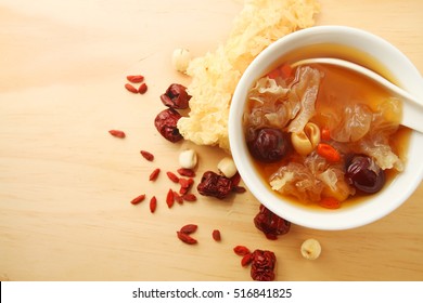 Chinese traditional white fungus or snow fungus soup over wooden table background