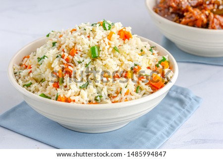 Chinese Vegetable Fried Rice in a Bowl with Side Dish  on White Background.