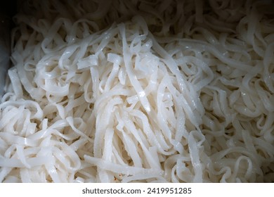 Chinese wet rice noodles or white noodles or also called kwetiau or kutiau - raw, broken down ready to be cooked. usually fried with duck eggs, a mixture of bean sprouts, shrimp and soy sauce