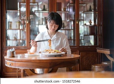 Chinese Woman Eating Asian Noodles
