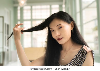 A Chinese Woman Holding Her Hair Inside A Sitting Room Within The Walters Art Museum In Baltimore Maryland.