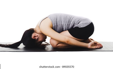 Chinese Woman On A Yoga Mat Doing The Childs Pose.