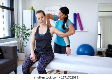 Chinese Woman Physiotherapy Professional Giving A Treatment To A