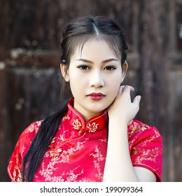 Chinese Woman Red Dress Traditional Cheongsam ,close Up Portrait With Old Wood Door