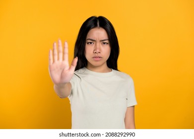 Chinese Woman Show To The Camera Gesture STOP. Struggle For Female Suffrage And Gender Equality, Against Domestic Violence And Racial Racism.Global Movement Of Women Rights Concept.Isolated Background