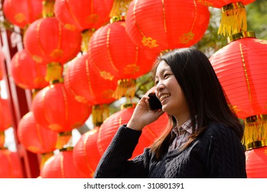 Chinese Woman Talking On Cell Phone During Chinese New Year