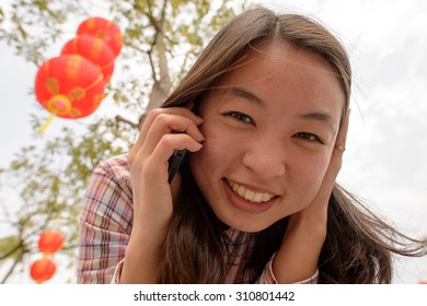 Chinese Woman Talking On Cell Phone During Chinese New Year